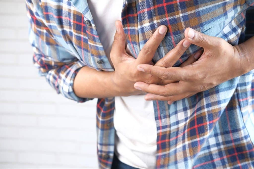 man clutching chest