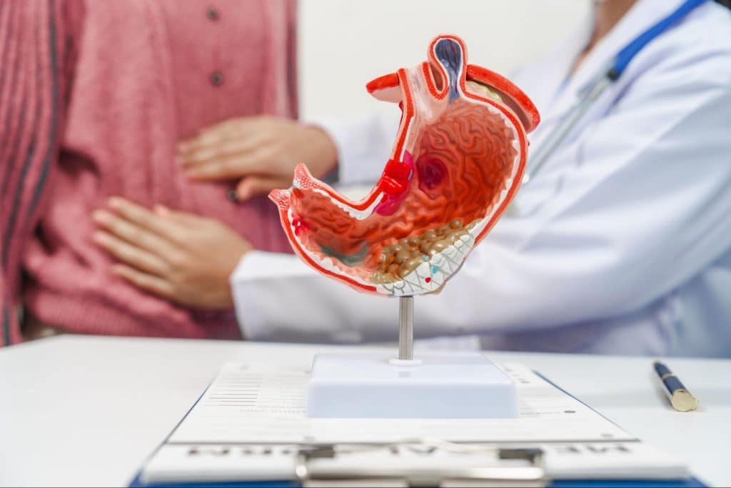 doctor feeling patient's abdomen