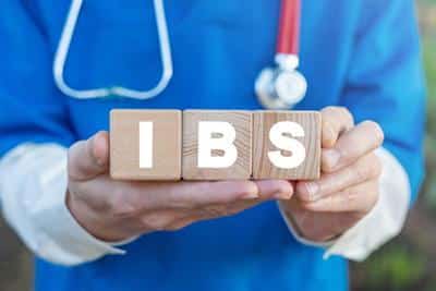 doctor holding out blocks that spell ibs