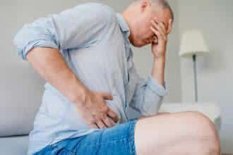 man holding stomach in pain